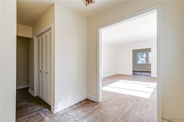 hallway featuring baseboards and wood finished floors