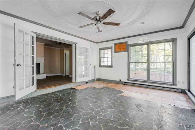 unfurnished room featuring a baseboard radiator, stone finish flooring, a fireplace with raised hearth, and crown molding