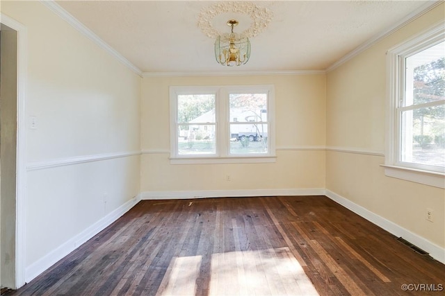 unfurnished room featuring crown molding, visible vents, dark wood finished floors, and baseboards