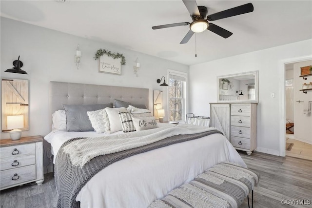 bedroom featuring a ceiling fan, baseboards, and wood finished floors