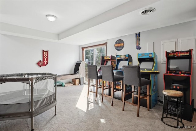 carpeted dining room featuring visible vents