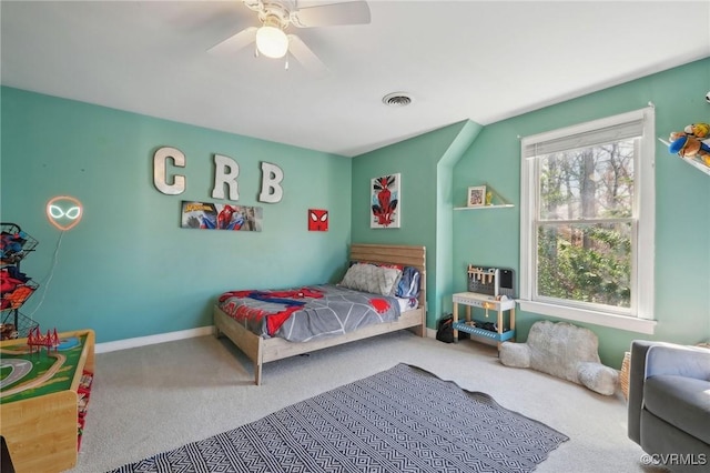 carpeted bedroom with ceiling fan, visible vents, and baseboards