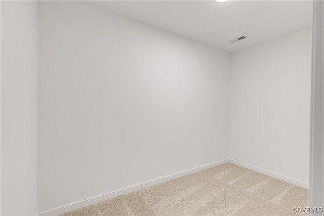 unfurnished room with light carpet, visible vents, and baseboards