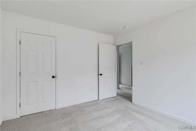 unfurnished bedroom with carpet floors and baseboards