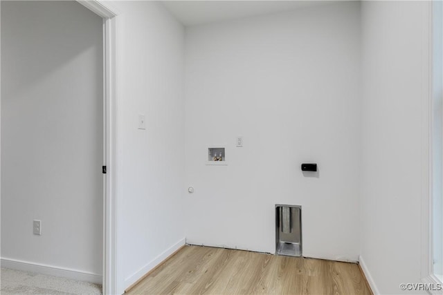 laundry area with gas dryer hookup, hookup for a washing machine, light wood-style flooring, and baseboards