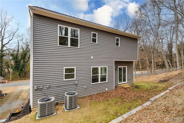 rear view of house featuring cooling unit