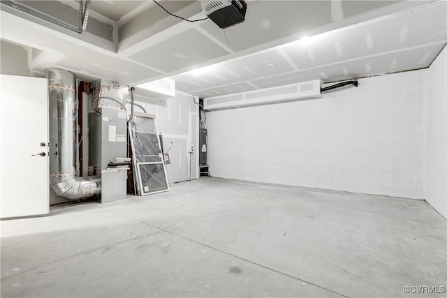 garage with a garage door opener and electric water heater