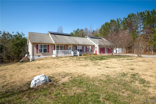 ranch-style house featuring a garage, a front lawn, roof mounted solar panels, a porch, and crawl space