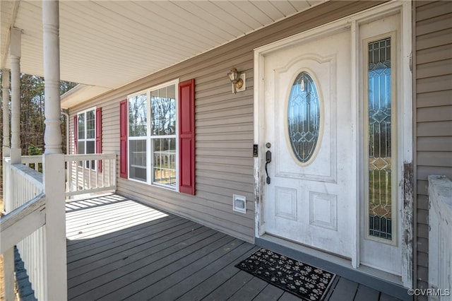 view of exterior entry featuring a porch