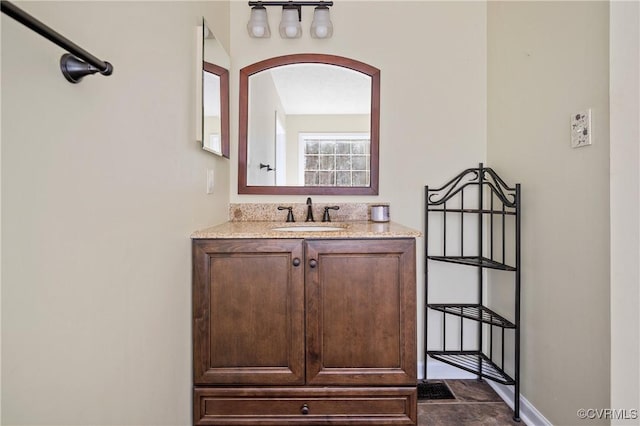 bathroom with vanity and baseboards