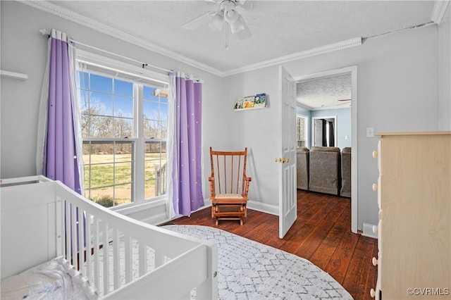 bedroom featuring ornamental molding, a textured ceiling, hardwood / wood-style floors, baseboards, and ceiling fan