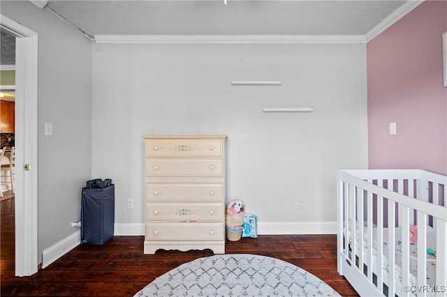 bedroom featuring crown molding, baseboards, and wood-type flooring