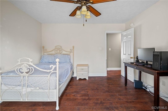 bedroom featuring a ceiling fan, baseboards, wood-type flooring, and a textured ceiling