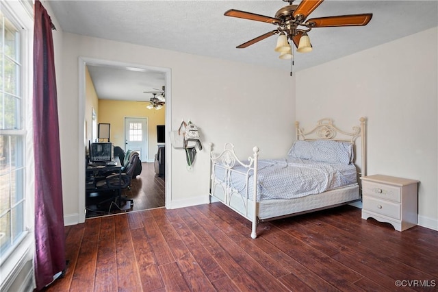 bedroom featuring baseboards, hardwood / wood-style floors, and a ceiling fan