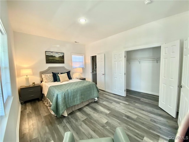 bedroom featuring baseboards and wood finished floors