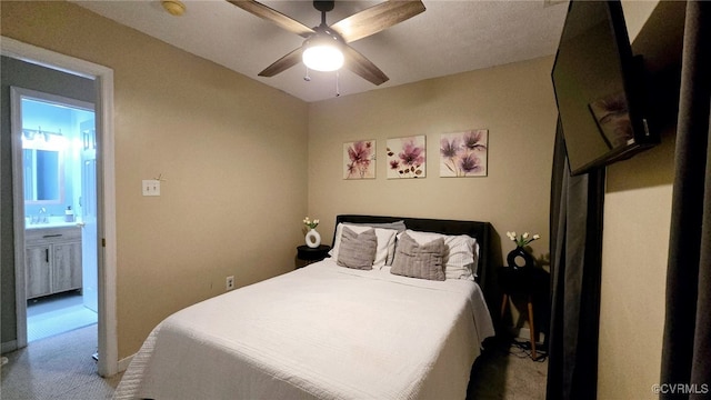 carpeted bedroom with a sink and a ceiling fan