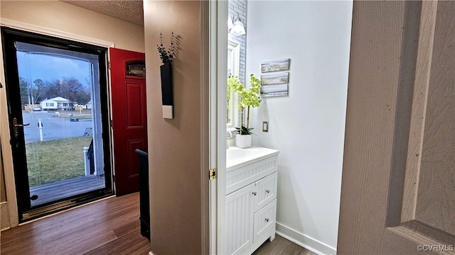 bathroom with vanity, baseboards, and wood finished floors