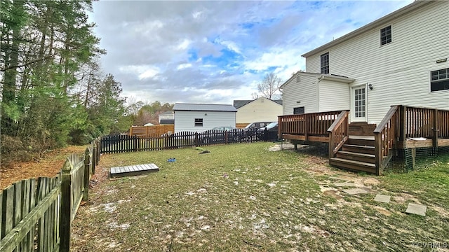 view of yard with a wooden deck and a fenced backyard