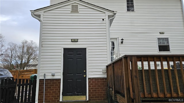 view of exterior entry with fence