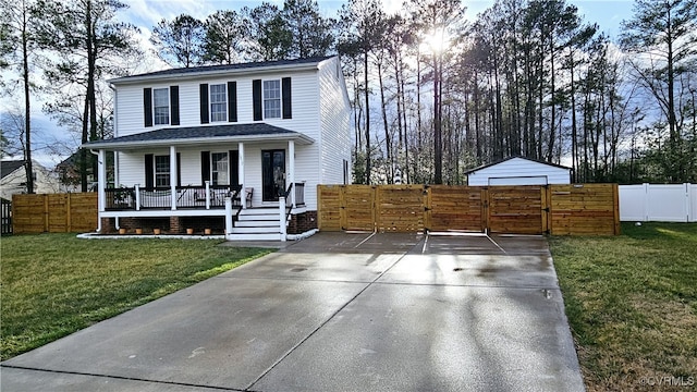 view of front of home with a porch, a gate, fence, and a front yard