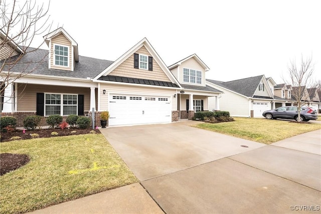 view of front of home featuring driveway, a front yard, and brick siding