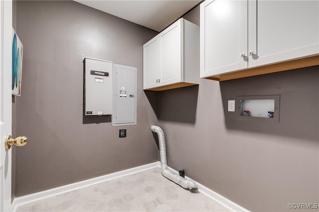 washroom with hookup for a washing machine, cabinet space, and baseboards