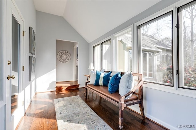 mudroom featuring lofted ceiling, baseboards, and wood finished floors