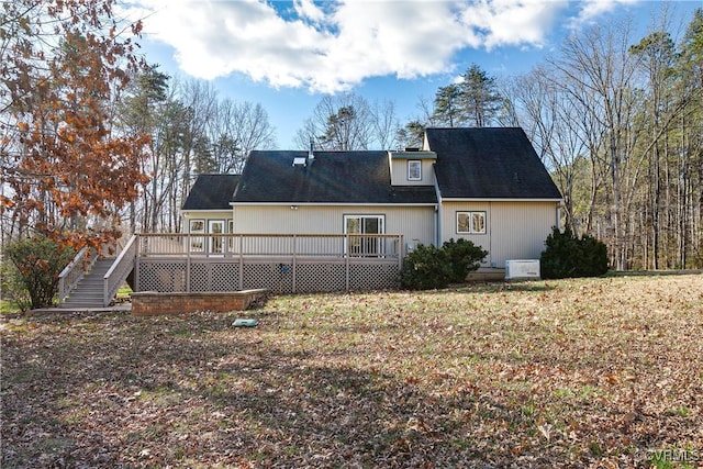 rear view of house featuring a wooden deck