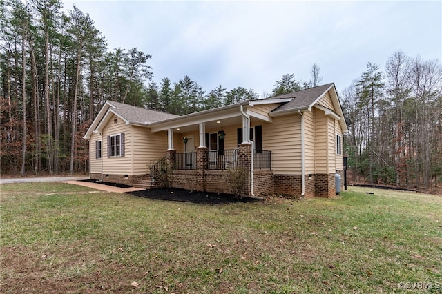 ranch-style home featuring a porch, crawl space, roof with shingles, and a front lawn