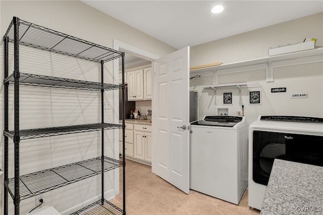 laundry area with light tile patterned floors, recessed lighting, and washer and dryer