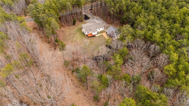 bird's eye view featuring a wooded view