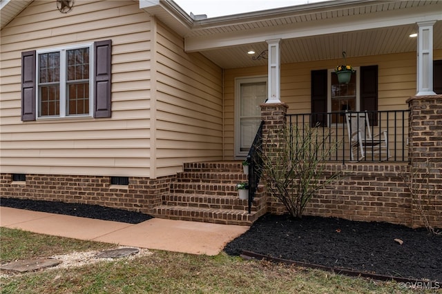 view of home's exterior with covered porch and crawl space