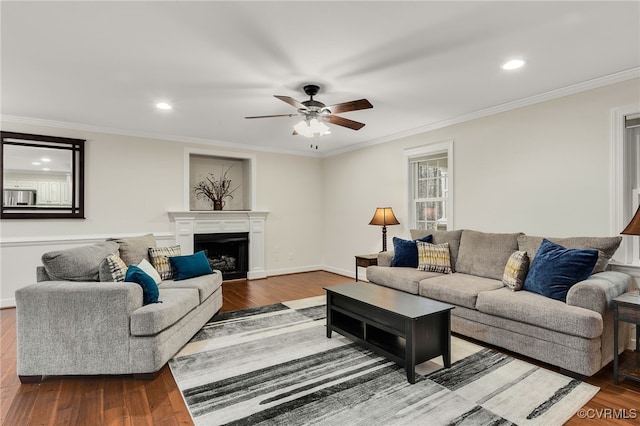 living room featuring baseboards, a fireplace, ornamental molding, and dark wood-style flooring