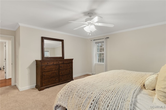 bedroom featuring baseboards, ornamental molding, a ceiling fan, and light colored carpet