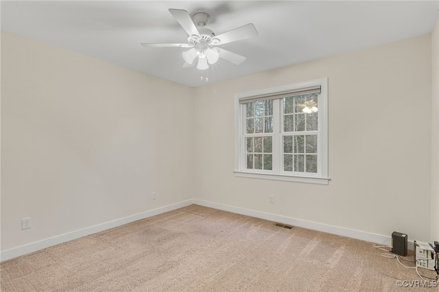 unfurnished room featuring visible vents, ceiling fan, light carpet, and baseboards