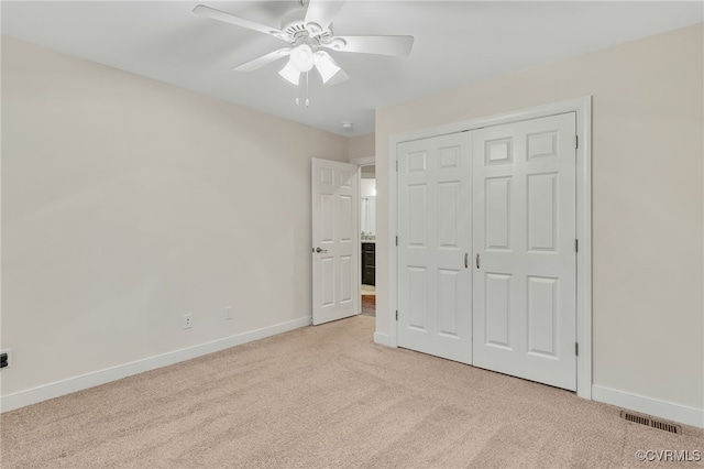 unfurnished bedroom with ceiling fan, light carpet, visible vents, baseboards, and a closet