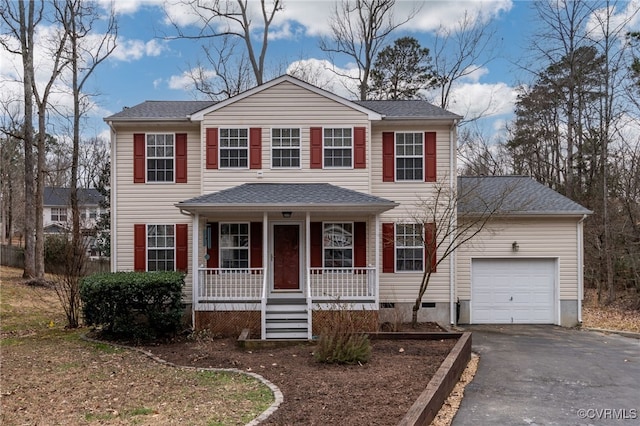 view of front of home with a shingled roof, covered porch, an attached garage, crawl space, and driveway