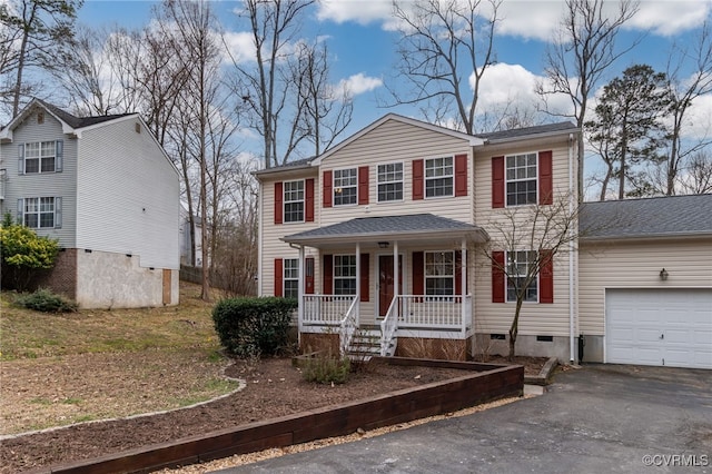 view of front of home featuring covered porch, aphalt driveway, crawl space, and an attached garage