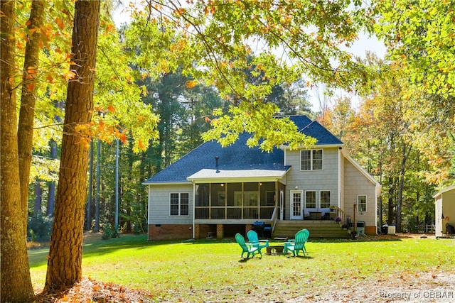 rear view of property with a sunroom, a yard, a fire pit, and crawl space