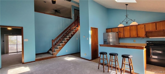 kitchen featuring stainless steel fridge with ice dispenser, brown cabinets, black / electric stove, carpet floors, and high vaulted ceiling