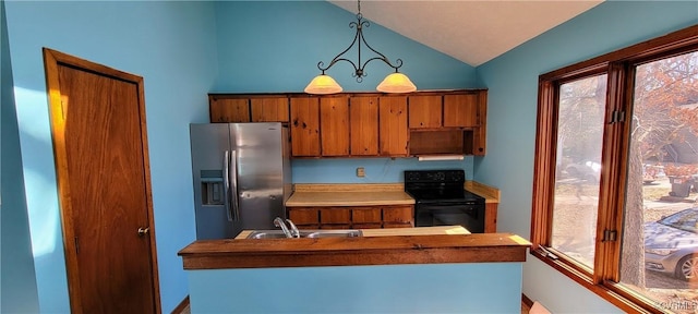 kitchen with brown cabinetry, lofted ceiling, black range with electric cooktop, stainless steel refrigerator with ice dispenser, and a sink