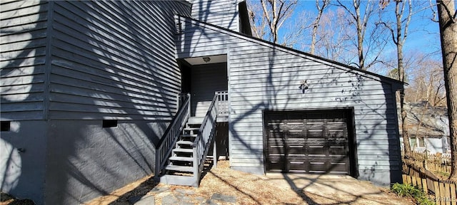 property entrance with a garage and fence