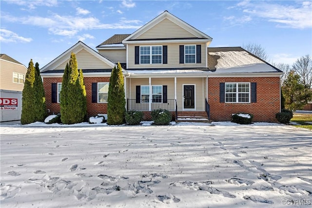 view of front of home featuring a porch and brick siding