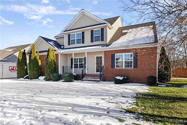 view of front facade featuring covered porch and brick siding