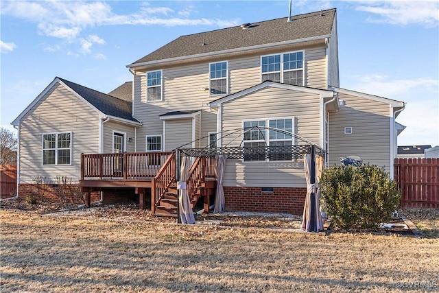 rear view of house featuring crawl space, fence, and a wooden deck