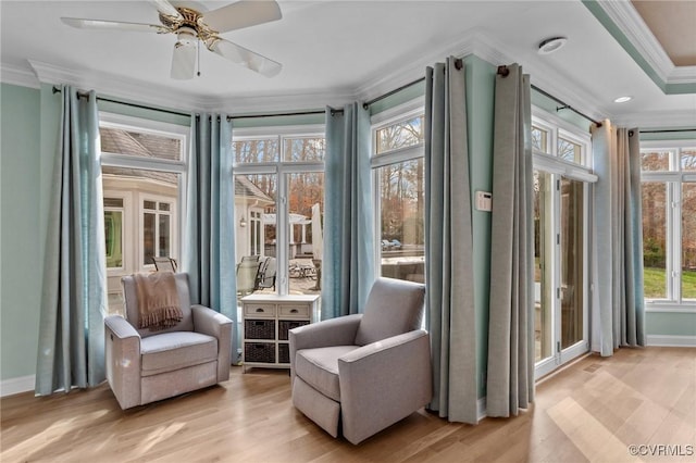 sunroom featuring ceiling fan