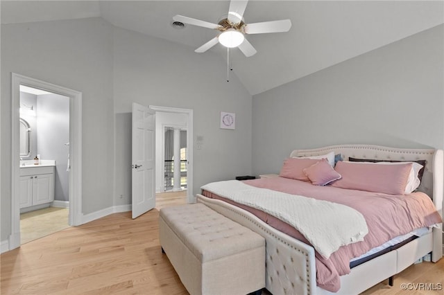 bedroom featuring ceiling fan, high vaulted ceiling, connected bathroom, baseboards, and light wood finished floors