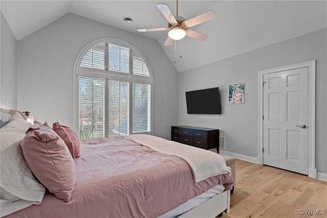 bedroom with baseboards, visible vents, a ceiling fan, vaulted ceiling, and light wood-type flooring