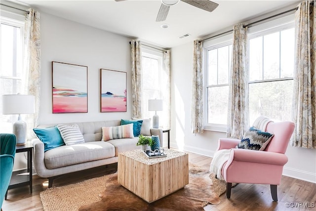 sitting room with a wealth of natural light, wood finished floors, and visible vents