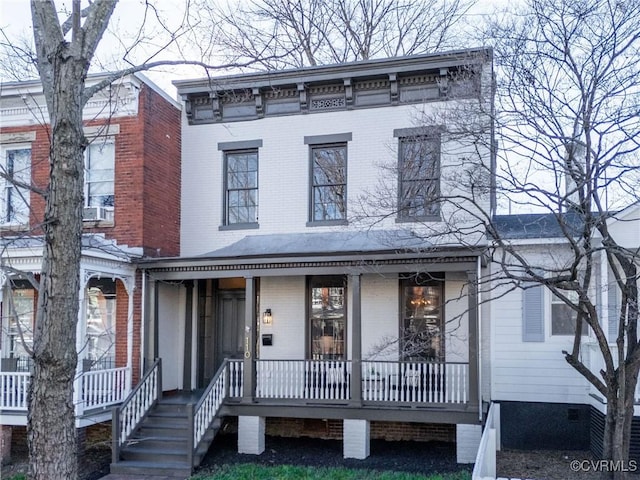 italianate home with covered porch and brick siding